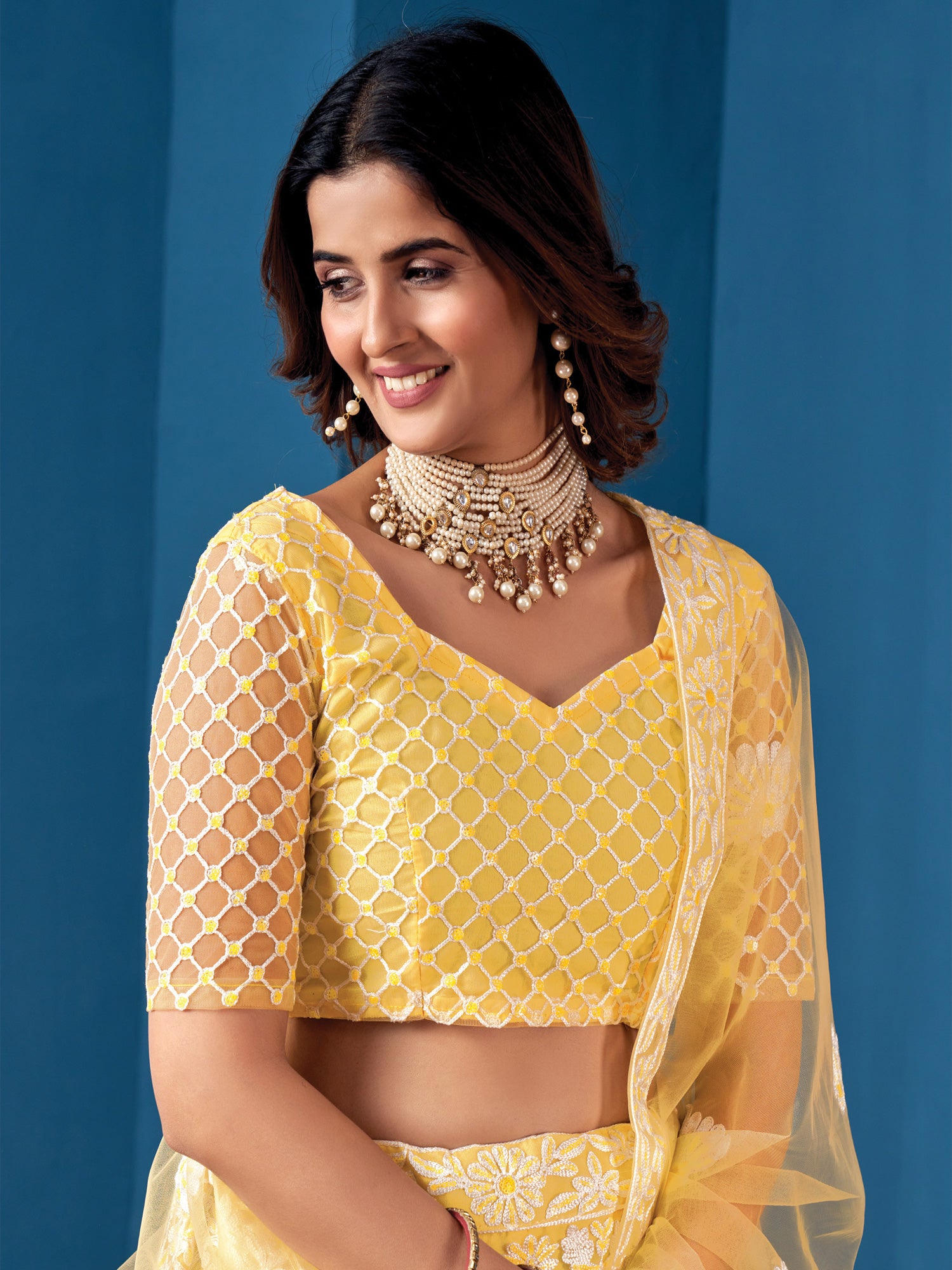 Yellow Heavy Thread Embroidered Lehenga Choli In Net