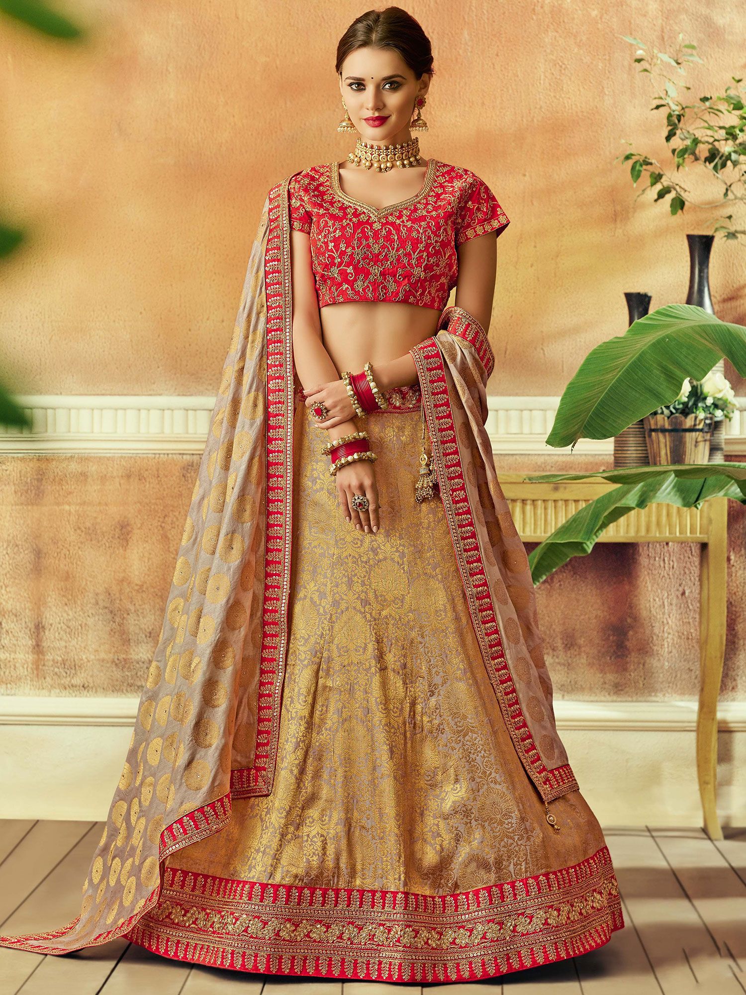 Fascinating Golden And Red Bridal Lehenga at best price in Delhi